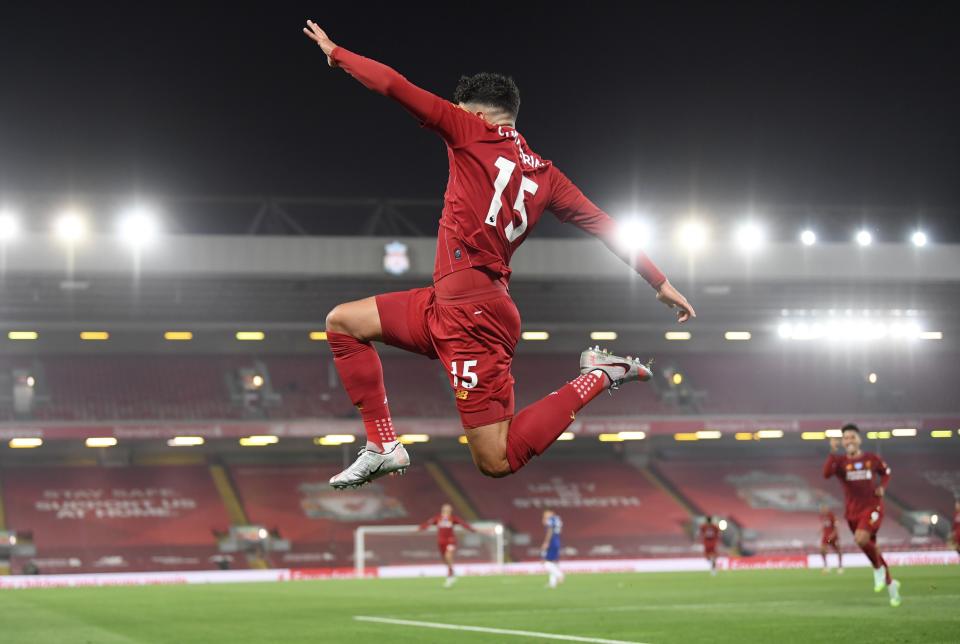 Liverpool's Alex Oxlade-Chamberlain celebrates scoring his side's fifth goal during the English Premier League soccer match between Liverpool and Chelsea at Anfield stadium in Liverpool, England, Wednesday, July 22, 2020. (Laurence Griffiths, Pool via AP)