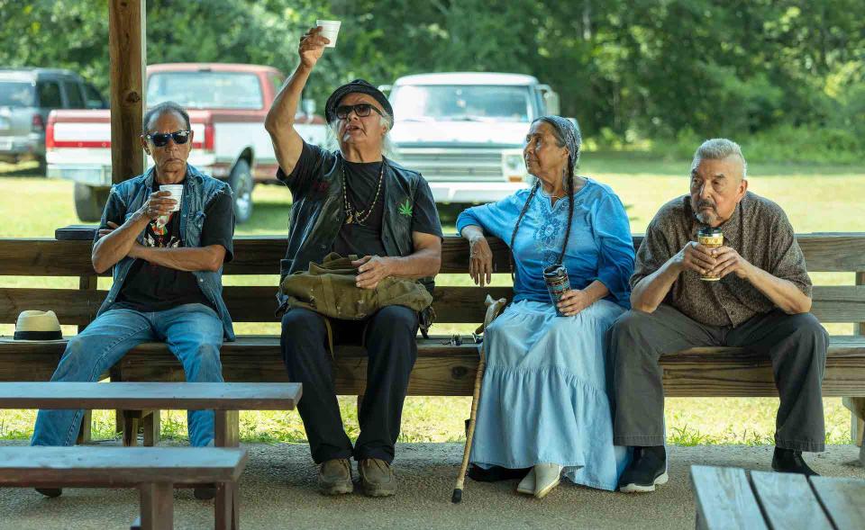 Four Native elders sitting on an outdoor bench, sipping coffee; still from "Reservation Dogs"