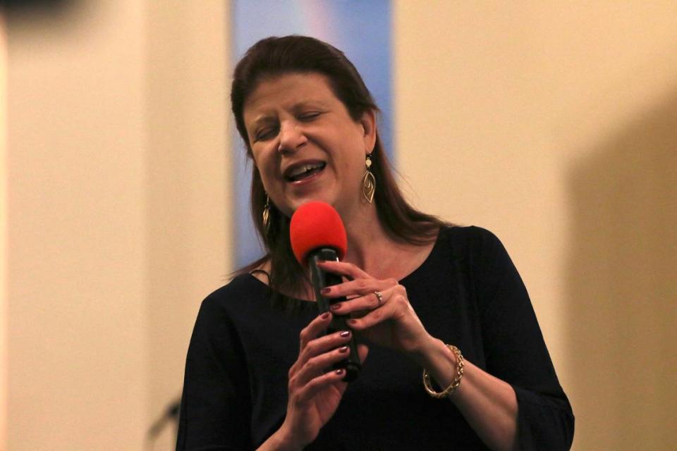 West Side Church of God music director Tracie Nice leads the choir and congregation during the song of adoration, “Great Is Thy Faithfulness,” during the last service on Sunday.