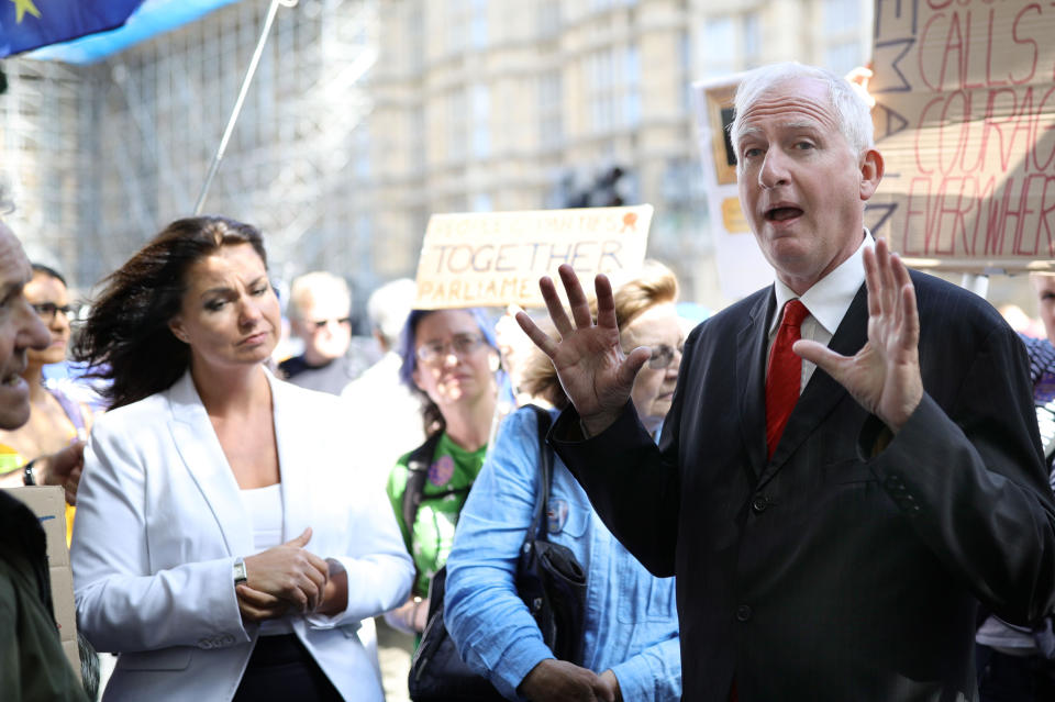 MP Heidi Allen (left) and Labour Party MP Daniel Zeichner speak to Brexit protesters outside the Houses of Parliament in Westminster, London.