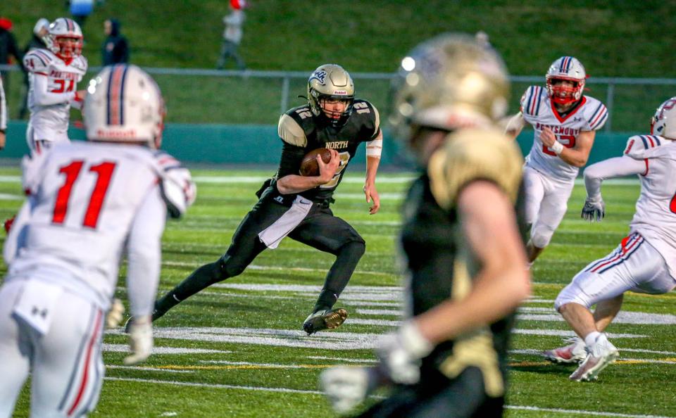 North Kingstown quarterback Eddie Buehler scrambles for yardage against St. Raphael on Friday.