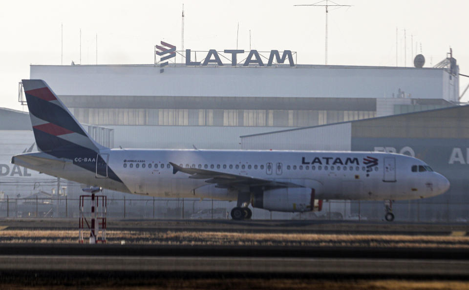 A Latam airplane sits parked at the Arturo Merino Benitez airport in Santiago, Chile, Tuesday, May 26, 2020. South America’s biggest carrier is seeking U.S. bankruptcy protection as it grapples with a sharp downturn in air travel sparked by the coronavirus pandemic. (AP Photo/Esteban Felix)