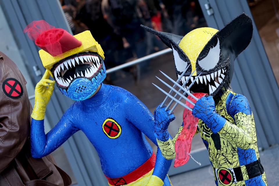 Cosplayers dressed as Symbiote Cyclops and Symbiote Wolverine at New York Comic Con 2022.