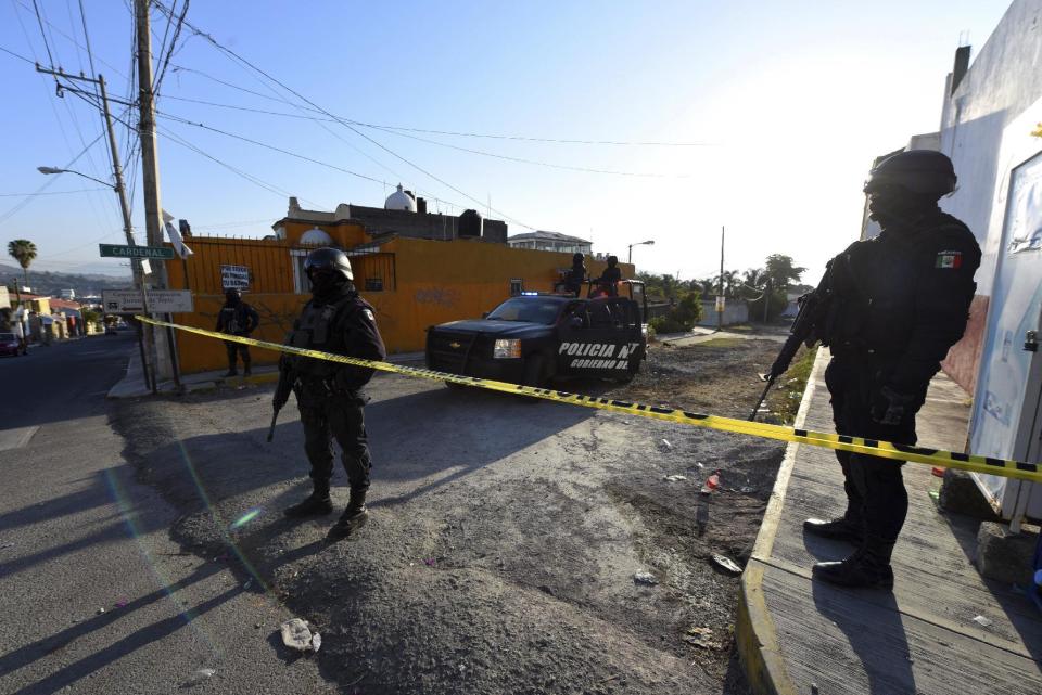 State police guard the area after a gun battle with Mexican Marines in which a suspect identified by authorities as the leader of the Beltran Leyva cartel, Juan Francisco Patron Sanchez and several accomplices died in the exchange, in Tepic, Nayarit state, Mexico, Friday, Feb. 10, 2017. The Interior Department said that Juan Francisco Patron Sanchez headed up the cartel's operations in the state of Nayarit and in the southern part of Jalisco state. (AP Photo/Chris Arias)