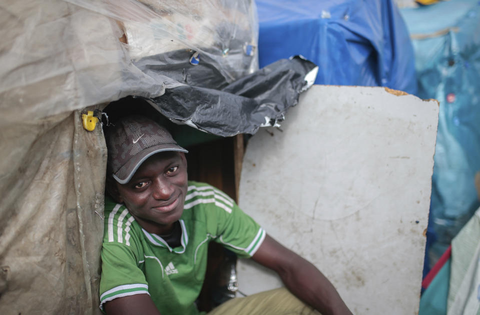 Wazzizi, a sub-Saharan migrant from Guinea, sits outside the tent where he lives at at Ouled Ziane camp in Casablanca, Morocco, Thursday, Dec. 6, 2018. As Morocco prepares to host the signing of a landmark global migration agreement next week, hundreds of migrants are languishing in a Casablanca camp rife with hunger, misery and unsanitary conditions. These sub-Saharan Africans who dream of going to Europe are a symbol of the problems world dignitaries are trying to address with the U.N.'s first migration compact. (AP Photo/Mosa'ab Elshamy)
