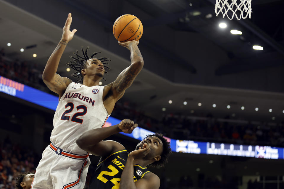 Auburn guard Allen Flanigan (22) shoots over Missouri guard Kobe Brown (24) during the second half of an NCAA college basketball game, Tuesday, Feb. 14, 2023, in Auburn, Ala. (AP Photo/Butch Dill)