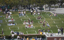 Baseball fans sit in social distance squares during a baseball game between the Arizona Diamondbacks and the San Diego Padres Thursday, April 1, 2021, on opening day in San Diego. (AP Photo/Denis Poroy)