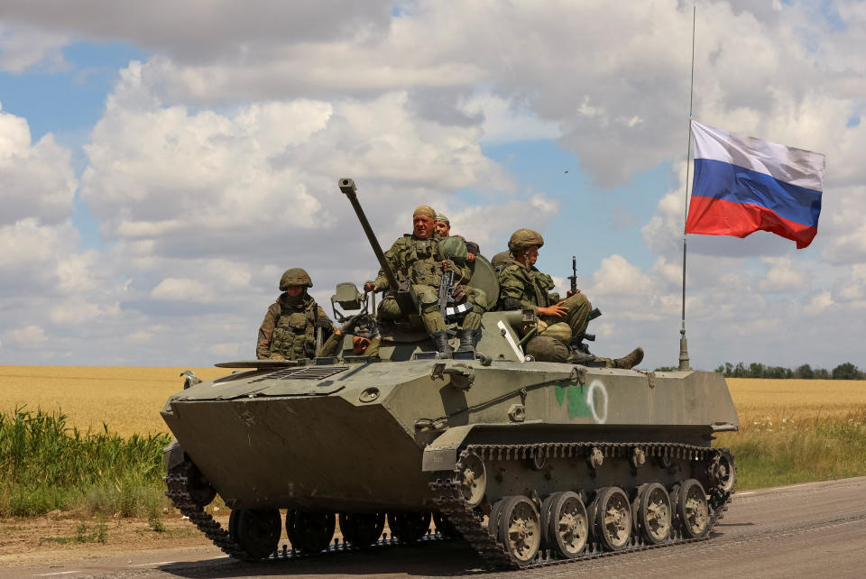 Service members of Russian troops ride on top an armoured vehicle in Russian-held part of Zaporizhzhia region, Ukraine, July 23, 2022.  REUTERS/Alexander Ermochenko