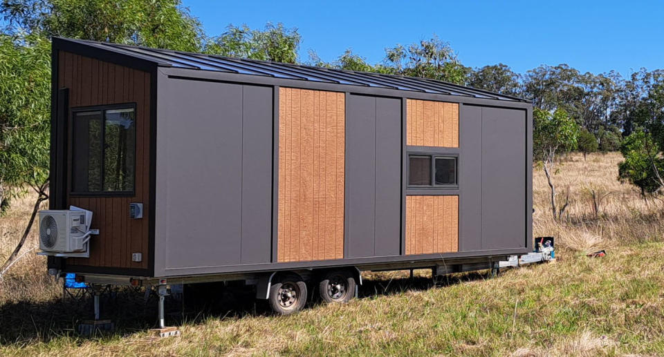 The exterior of a tiny home set on land in Queensland. 