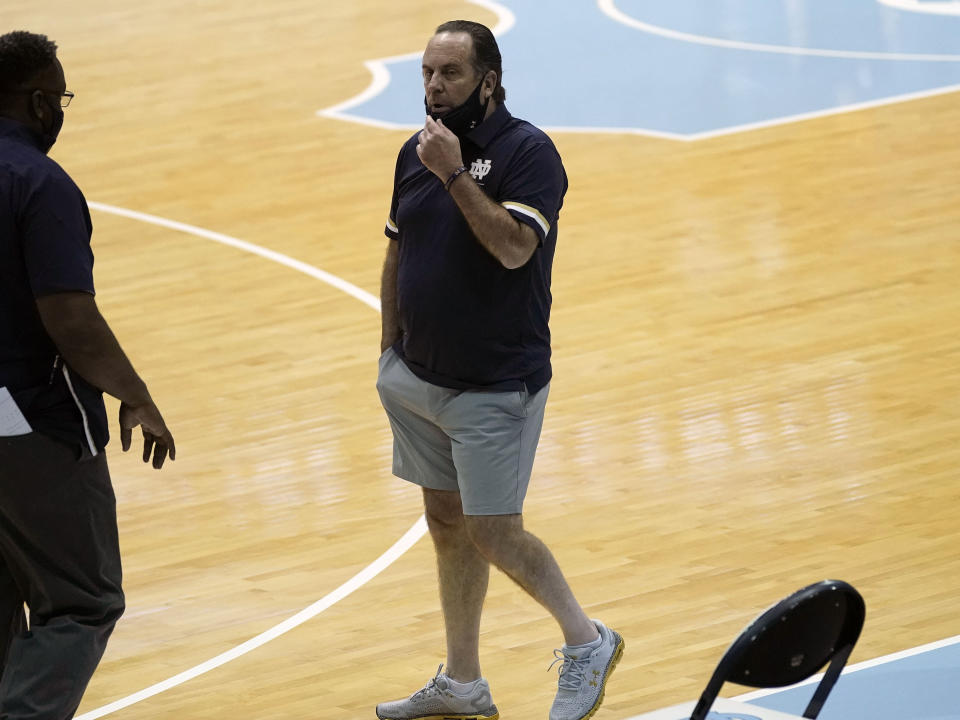 Notre Dame head coach Mike Brey looks on before an NCAA college basketball game against North Carolina in Chapel Hill, N.C., Saturday, Jan. 2, 2021. Brey said he took the notion of acceptable coaching attire to a "ridiculously new level" for the Jan. 2 game at North Carolina. He said wanted to loosen up his players, so he put on the gray shorts under his blue polo. (AP Photo/Gerry Broome)