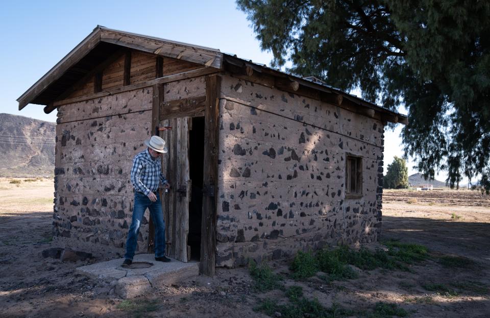 Dax Hansen opens the door to the 1917 Kreager homestead on Feb. 20, 2023, on his Oatman Flats Ranch in Dateland, Arizona.