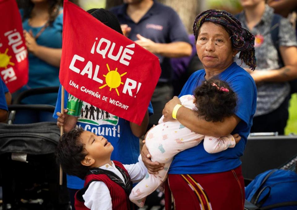 Lucia Quiej, center, field worker since 1993, attends a “¡Qué Calor!” rally by WeCount with her grandchildren calling for better working conditioning for outdoor workers before a Miami-Dade county commission Community Health Committee meeting on Monday, Sept. 11, 2023, at Government Center in Miami. The committee was voting on a bill called the Miami-Dade Heat standard for outdoor workers that would would create protections for outdoor workers on hot days like water, shade, and breaks. Quiej wants her grandchildren to remember the importance of community and standing up for what is right. Alie Skowronski/askowronski@miamiherald.com