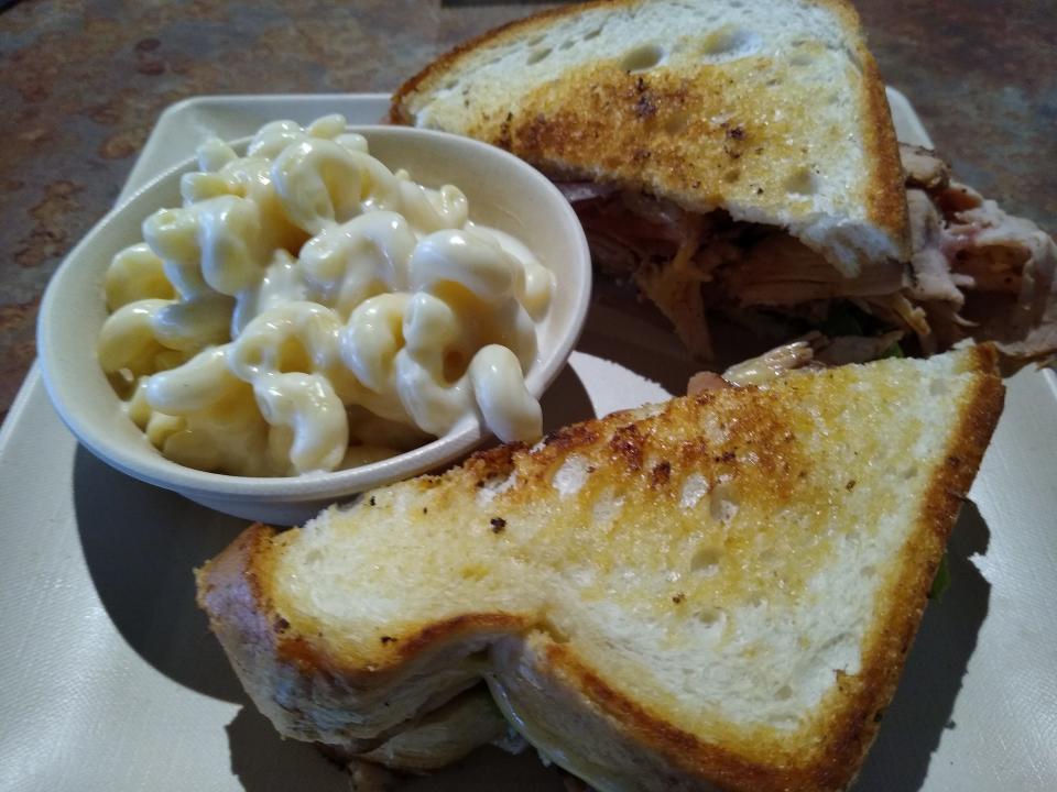 A Jerk smoked turkey breast sandwich is served with mac and cheese at the Great Oaks Tavern in Wadsworth.