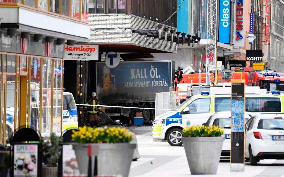 The truck embedded in the Ahlens department store - Credit: JONATHAN NACKSTRAND/AFP