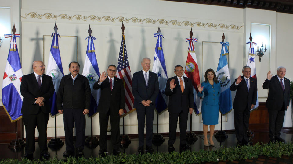 US Vice President Joe Biden, center, posses for a group photo with, from left to right, Dominican Republic Foreign Affairs Minister Carlos Morales, Nicaragua's President Daniel Ortega, El Salvador's President Mauricio Funes, Biden, Hondura's President Porfirio Lobo, Costa Rica's President Laura Chinchilla, Guatemala's President Otto Perez, and Panama's President Ricardo Martinelli, at the Presidential House in Tegucigalpa, Honduras, Tuesday, March, 6, 2012. Biden is on a one-day visit to Honduras. (AP Photo/Esteban Felix)