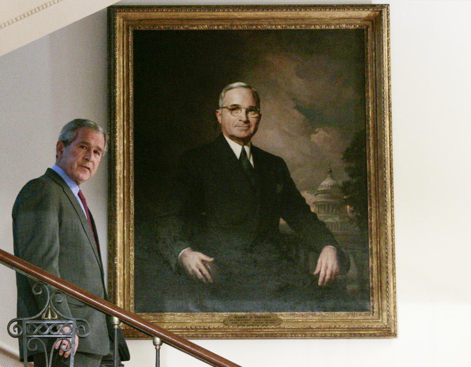 FILE - President George W. Bush walks past a portrait of former President Harry S. Truman as he descends the Grand Staircase of the White House in Washington, May 16, 2007. (AP Photo/Charles Dharapak, File)