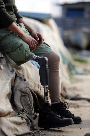 Mutassim al-Misrati, a Benghazi-local who lost his leg during a three-year war in the city, smokes a cigarette as he sits at Benghazi port, Libya December 27, 2017. Picture taken December 27, 2017. REUTERS/Esam Omran Al-Fetori