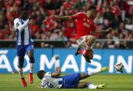 Benfica's Jonas Oliveira (R) is tackled by Porto's Ricardo Quaresma during their Portuguese premier league soccer match at Luz stadium in Lisbon April 26, 2015. REUTERS/Rafael Marchante