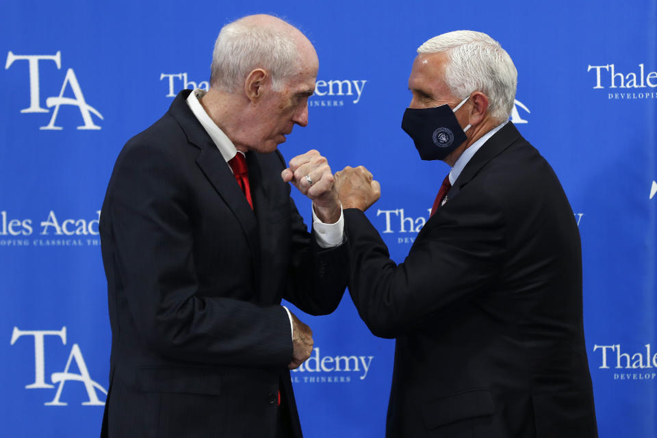 Vice President Mike Pence, right, is greeted by Bob Luddy, Founder of Thales Academy, which reopened to students in Apex, N.C., Wednesday, July 29, 2020. (AP Photo/Gerry Broome)