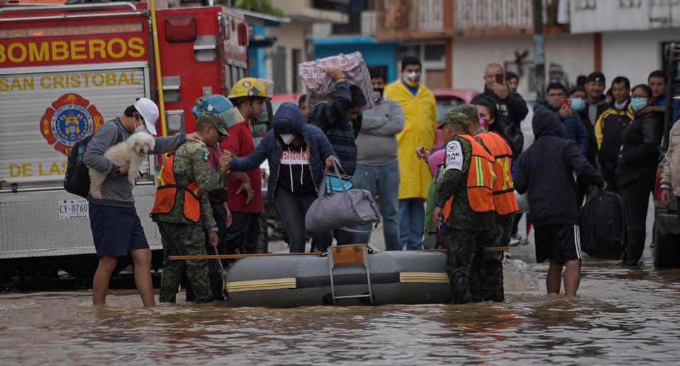 State police evacuate families from the flooded area in the municipality of San Cristobal de las Casas, in the state of Chiapas, Mexico.