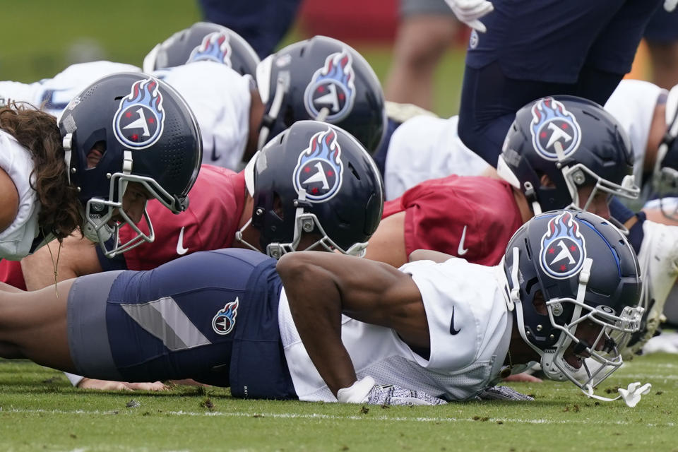 Tennessee Titans players do pushups after a drill at the NFL football team's practice facility Tuesday, May 24, 2022, in Nashville, Tenn. (AP Photo/Mark Humphrey)