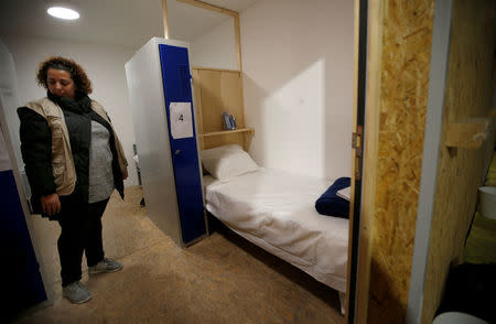 A charity worker stands in a room at the reception center for migrants and refugees near porte de La Chapelle in the north of Paris, France, November 25, 2016. REUTERS/Jacky Naegelen