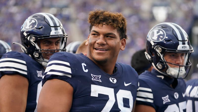 BYU offensive lineman Kingsley Suamataia, right, looks on from the sidelines during game against Southern Utah, Saturday, Sept. 9, 2023, in Provo, Utah.