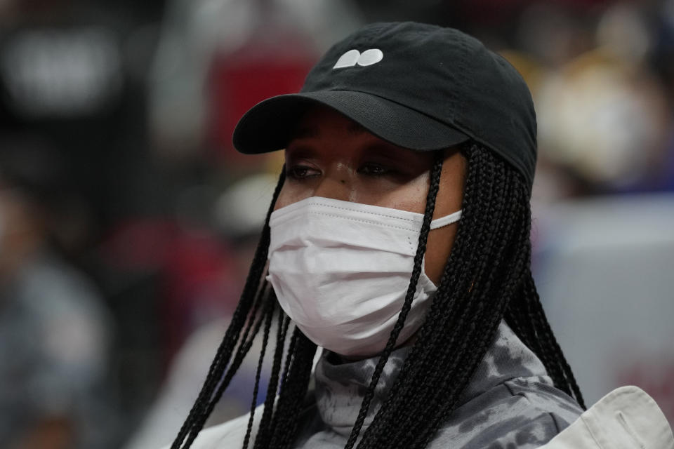 Japanese tennis player Naomi Osaka attends the preseason NBA basketball game between Golden State Warriors and Washington Wizards, Friday, Sept. 30, 2022, at Saitama Super Arena, in Saitama, north of Tokyo. (AP Photo/Eugene Hoshiko)