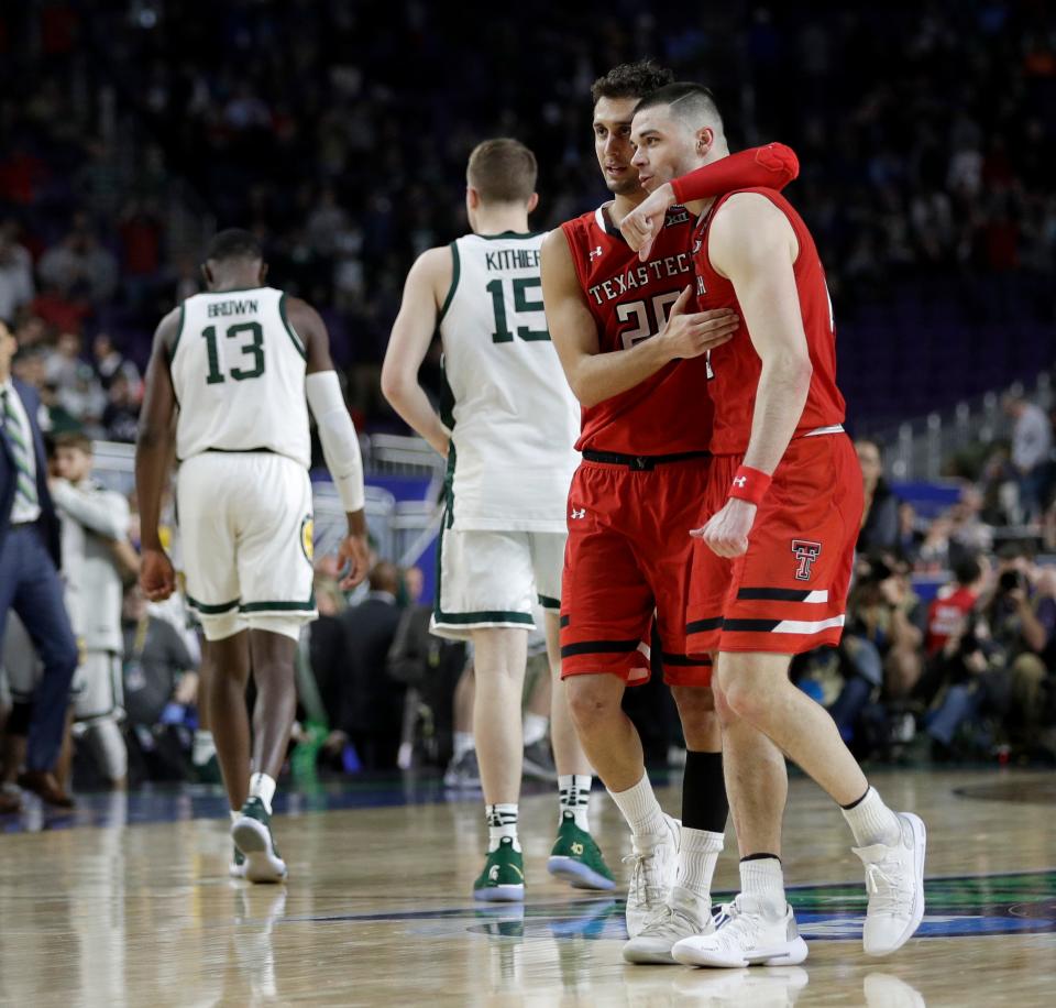 Texas Tech's Davide Moretti (25) and Matt Mooney celebrate after defeating Michigan State 61-51 in the second half in the semifinals of the Final Four NCAA college basketball tournament, Saturday, April 6, 2019, in Minneapolis. (AP Photo/David J. Phillip)