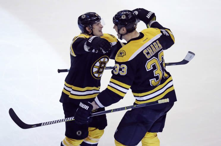 Boston Bruins defenseman Zdeno Chara (33) is congratulated by Torey Krug after his goal off Tampa Bay Lightning goalie Andrei Vasilevskiy during the third period of an NHL hockey game in Boston, Tuesday, April 4, 2017. The Bruins defeated the Lightning 4-0.(AP Photo/Charles Krupa)