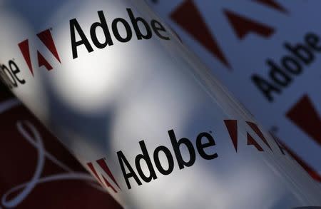 Adobe company logos are seen in this picture illustration taken in Vienna July 9, 2013. REUTERS/Leonhard Foeger