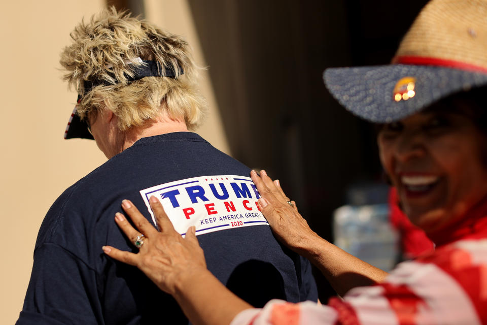 GOODYEAR, ARIZONA - OCTOBER 28:  Supporters of U.S. President Donald Trump attend a campaign rally with Tru at Phoenix Goodyear Airport October 28, 2020 in Goodyear, Arizona. With less than a week until Election Day, Trump and his opponent, Democratic presidential nominee Joe Biden, are campaigning across the country. (Photo by Chip Somodevilla/Getty Images)