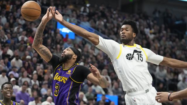 Los Angeles Lakers forward <a class="link " href="https://sports.yahoo.com/nba/players/5007" data-ylk="slk:Anthony Davis;elm:context_link;itc:0">Anthony Davis</a> and Utah Jazz center Damian Jones reach for a rebound during game Tuesday, April 4, 2023, in Salt Lake City. | Rick Bowmer, Associated Press