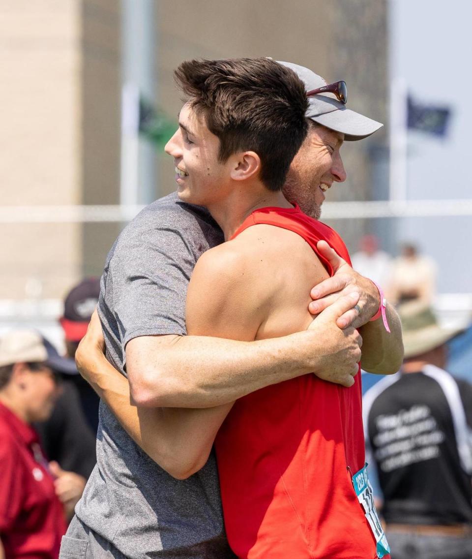 Seth Nelson of Boise High School hugs his coach Asa Nims after clearing 16 feet, 8 inches in the 5A boys pole vault at the state track and field championships Friday at Mountain View High.