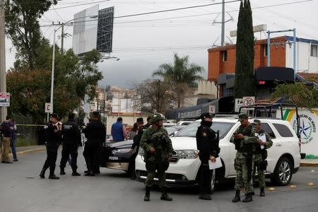 Police officers and soldiers gather near the Colegio Americano del Noreste after a student opened fire at the American school in Monterrey, Mexico January 18, 2017. REUTERS/Daniel Becerril
