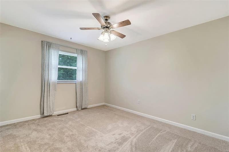 Carpeted bedroom before renovation.