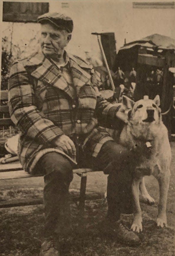 Harry Chinery sits with his dog, Rex, after allowing Pennsylvania Department of Transportation surveyors working on Interstate 78 on his Lower Saucon Township property in 1983.