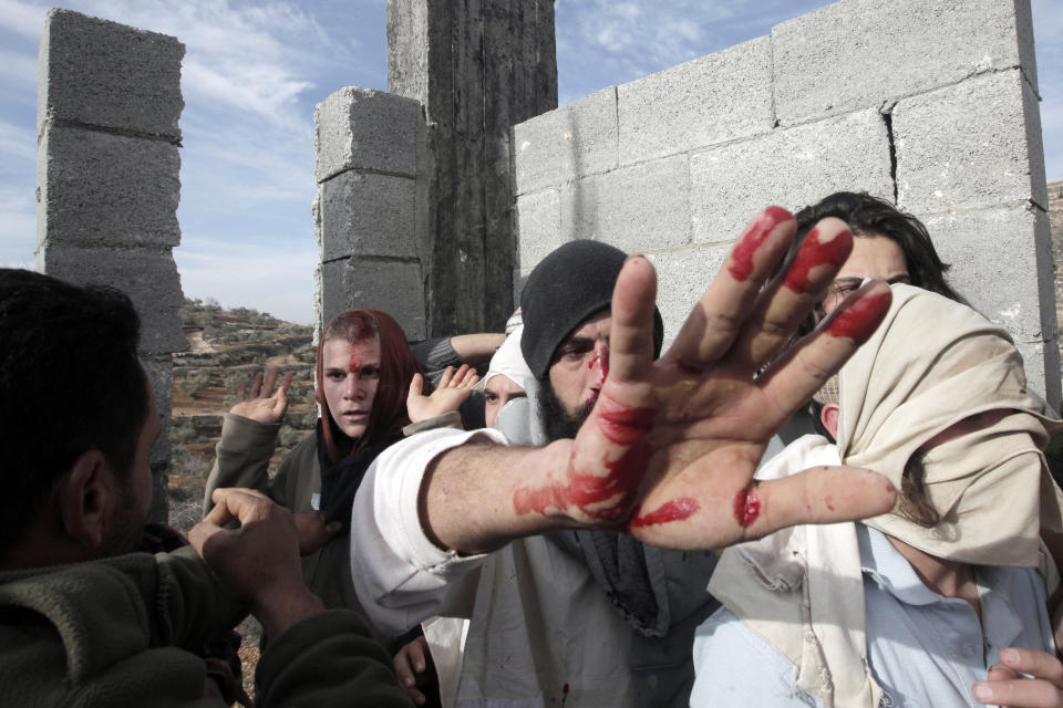 Israeli settlers are seen as they are detained and beaten by Palestinians from the village of Qusra at a construction site,  on January 7, 2014. (JAAFAR ASHTIYEH/AFP/Getty Images)