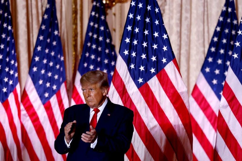 Former US President Donald Trump applauds while speaking at the Mar-a-Lago Club in Palm Beach, Florida, on November 15, 2022. - Donald Trump pulled the trigger on a third White House run on November 15, setting the stage for a bruising Republican nomination battle after a poor midterm election showing by his hand-picked candidates weakened his grip on the party. Trump filed his official candidacy papers with the US election authority moments before he was due to publicly announce his candidacy.