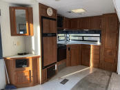 The kitchen initially donned wood paneling and outdated appliances and upholstery.