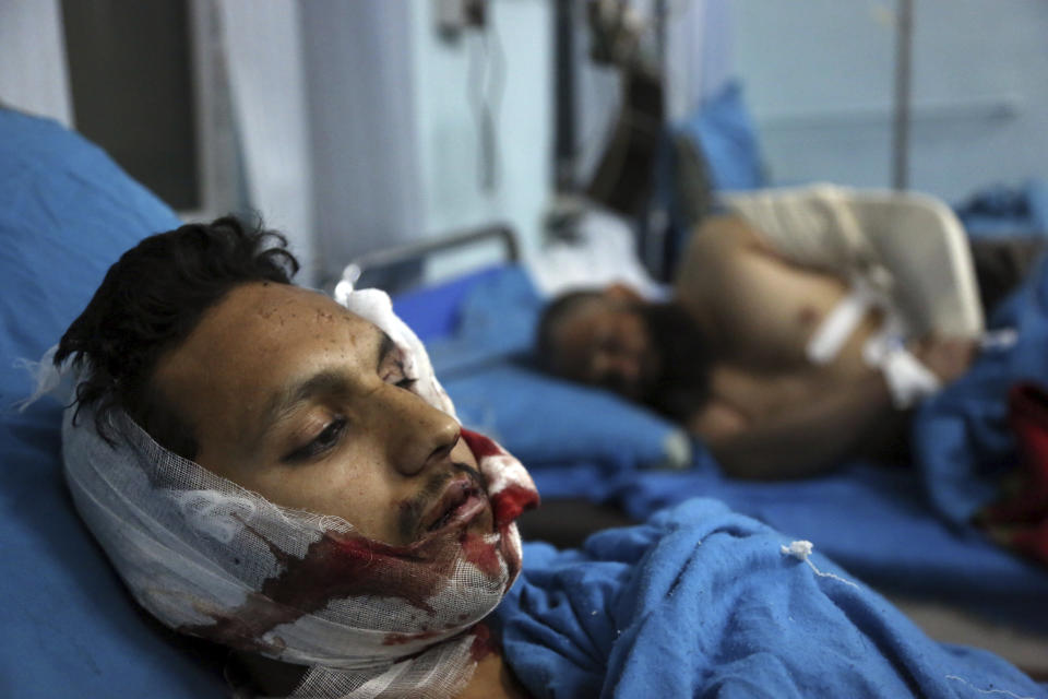 Injured men receive treatment at a hospital after a suicide bombing in Kabul, Afghanistan, Nov. 20, 2018. Afghan officials said the suicide bomber targeted a gathering of Muslim religious scholars. (AP Photo/Rahmat Gul)