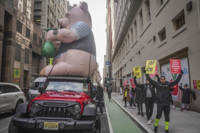 Major League Soccer (MLS) referees and supporters picket outside MLS headquarters.