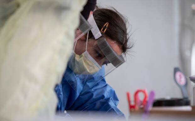 Nurses with the William Osler Health System perform COVID-19 testing at a drive-in centre near Etobicoke General Hospital in Toronto on April 14, 2020. (Evan Mitsui/CBC - image credit)