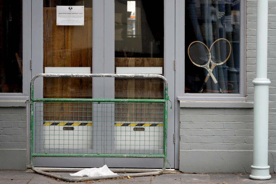 Two tennis racquets propped in the window of a closed pub in Wimbledon in London, Monday, June 29, 2020. The 2020 Wimbledon Tennis Championships, due to start Monday were cancelled due to the Coronavirus pandemic. (AP Photo/Kirsty Wigglesworth)