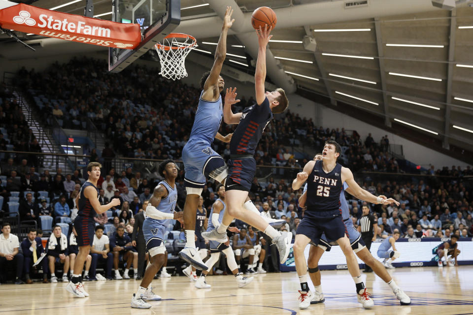 Pennsylvania's Ryan Betley, center right, tries to get a shot past Villanova's Jermaine Samuels, center left, during the first half of an NCAA college basketball game Wednesday, Dec. 4, 2019, in Villanova, Pa. (AP Photo/Matt Slocum)