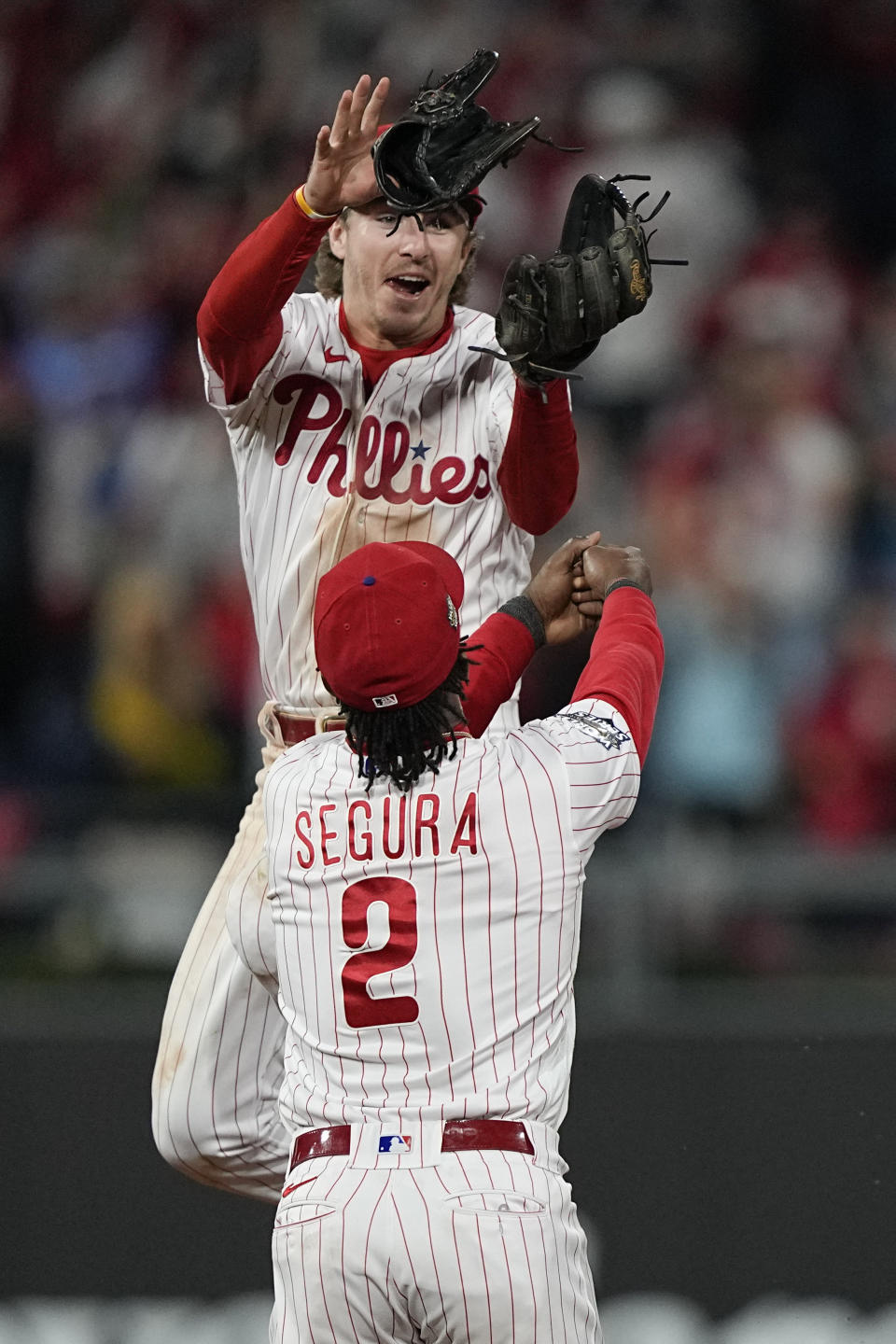 Philadelphia Phillies shortstop Bryson Stott and second baseman Jean Segura celebrate their win in Game 3 of baseball's World Series between the Houston Astros and the Philadelphia Phillies on Tuesday, Nov. 1, 2022, in Philadelphia. The Phillies won 7-0 to take one game lead in the best of seven series. (AP Photo/David J. Phillip)
