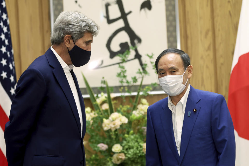 U.S. Special Presidential Envoy for Climate John Kerry, left, meets Japanese Prime Minister Yoshihide Suga at Suga's official residence in Tokyo Tuesday, Aug. 31, 2021. Kerry met with Japan's top diplomat to push efforts to fight climate change ahead of a United Nations conference in November. (Behrouz Mehri/Pool Photo via AP)