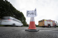 Vehicles arrive at a petrol station, in Manchester, England, Tuesday, Sept. 28, 2021. Thousands of British gas stations have run dry, as motorists scrambled to fill up amid a supply disruption due to a shortage of truck drivers. Long lines of vehicles formed at many gas stations over the weekend, and tempers frayed as some drivers waited for hours. (AP Photo/Jon Super)