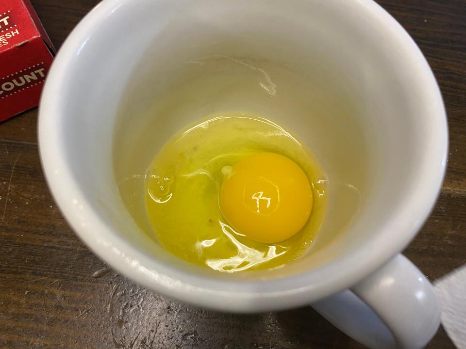 a raw egg in a mug
