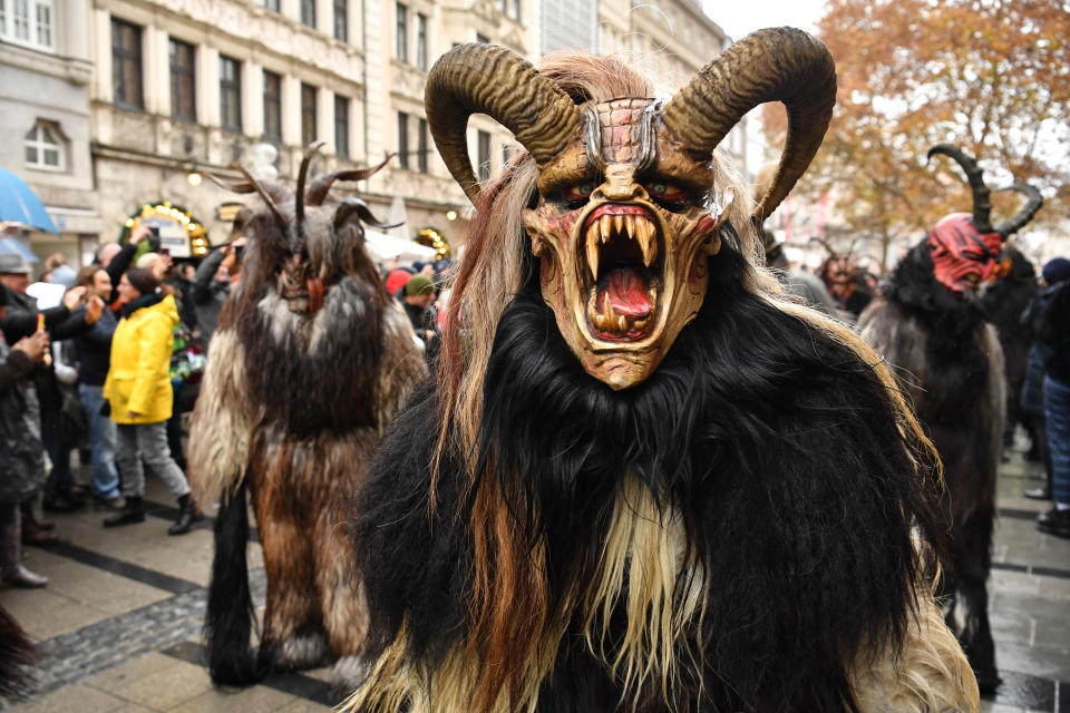 MUNICH, GERMANY - DECEMBER 09: Actors dressed as the Krampus creature parade through the city center's pedestrian shopping district on December 9, 2018 in Munich, Germany. Krampus traditionally accompanies Saint Nicholas and angels in a house to house procession to reward children who have been good and warn those who have not, though in recent decades Krampus parades have become an intrinsic part of local folklore and take place throughout the end of November and into the first half of December in the alpine regions of Germany, Austria and Italy. Krampus usually wears large cowbells on his back that he rings by shaking his hips to ward off the evil spirits of winter. He also carries a switch made of branches or animal hair that he uses to whip bystanders. (Photo by Sebastian Widmann/Getty Images)